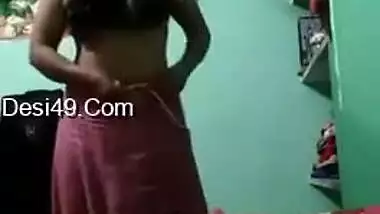 Desi brunette XXX strips to show her huge tits and fluffy pussy